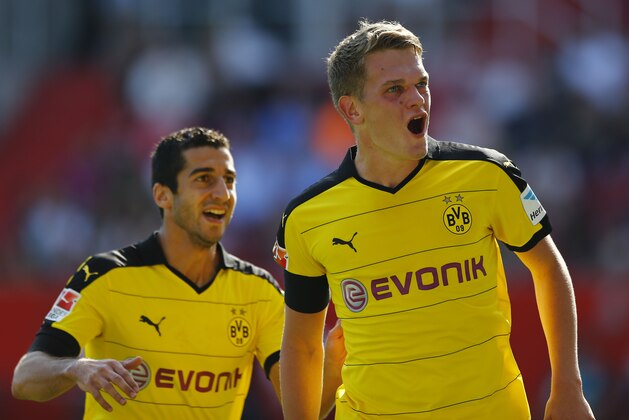 Dortmund's Matthias Ginter, right, and teammate Henrikh Mkhitaryan celebrate after the opening goal during the German Bundesliga soccer match between FC Ingolstadt 04 and Borussia Dortmund in Ingolstadt, Germany, Sunday, Aug. 23, 2015. (AP Photo/Matthias Schrader)