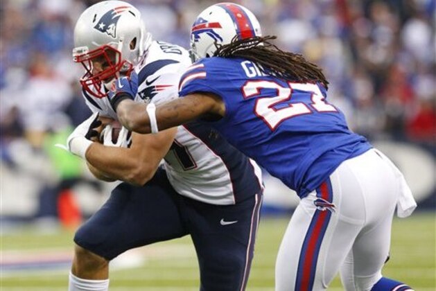 New England Patriots' Rob Gronkowski (87) makes a catch under pressure from Buffalo Bills' Stephon Gilmore (27) during the first quarter of an NFL football game in Orchard Park, N.Y., Sunday, Sept. 30, 2012. (AP Photo/Bill Wippert)