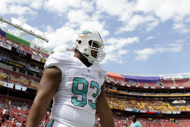 Miami Dolphins defensive tackle Ndamukong Suh (93) warms up before an NFL football game against the Washington Redskins, Sunday, Sept. 13, 2015, in Landover, Md. (AP Photo/Mark Tenally)