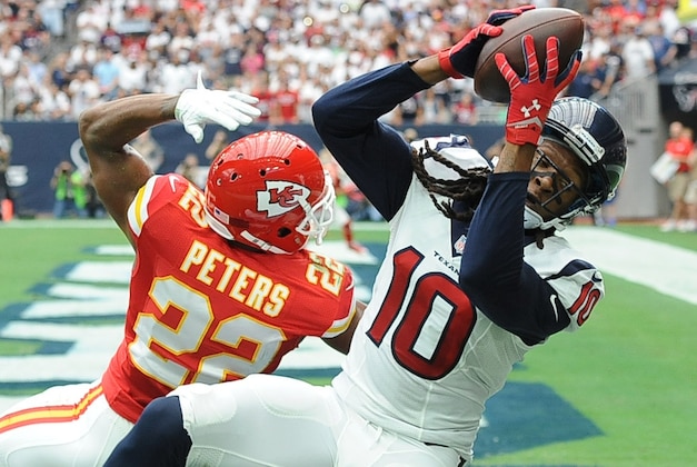 Houston Texans' DeAndre Hopkins (10) catches a touchdown pass over Kansas City Chiefs defender Marcus Peters (22) during the first half of an NFL football game Sunday, Sept. 13, 2015, in Houston. (AP Photo/George Bridges)