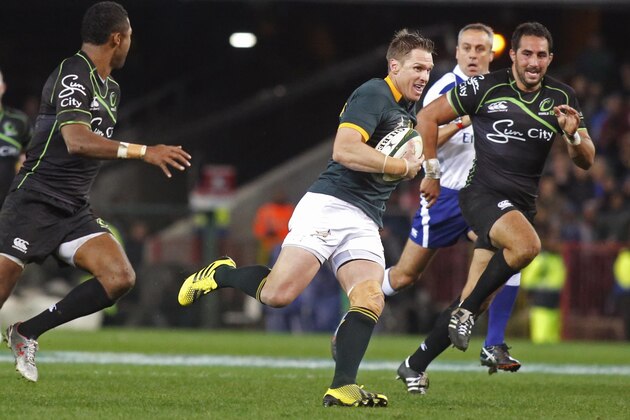 Springboks Jean de Villiers, center, runs with the ball during the game against the World XV rugby team in Cape Town, South Africa,  Saturday, July 11, 2015.  (AP Photo/Schalk van Zuydam)