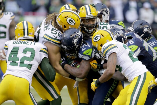 Seattle Seahawks running back Marshawn Lynch (24) is stopped by Green Bay Packers outside linebacker Clay Matthews (52) during the second half of the NFL football NFC Championship game Sunday, Jan. 18, 2015, in Seattle. (AP Photo/Ted S. Warren)