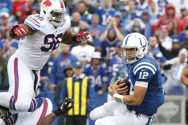 Indianapolis Colts quarterback Andrew Luck (12) is tackled by Buffalo Bills defensive tackle Stefan Charles (96) and linebacker Jerry Hughes (55) during the second half of an NFL football game  on Sunday, Sept. 13, 2015, in Orchard Park, N.Y. (AP Photo/Bill Wippert)