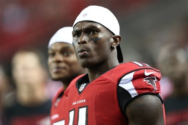 FILE - In this Aug. 14, 2015, file photo, Atlanta Falcons wide receiver Julio Jones (11) watches from the sidelines during the second half of an NFL football preseason game against the Tennessee Titans in Atlanta. As his agent negotiates a new contract with the Falcons, two-time Pro Bowl receiver Julio Jones goes about his business as if nothing has changed. (AP Photo/John Bazemore, File)