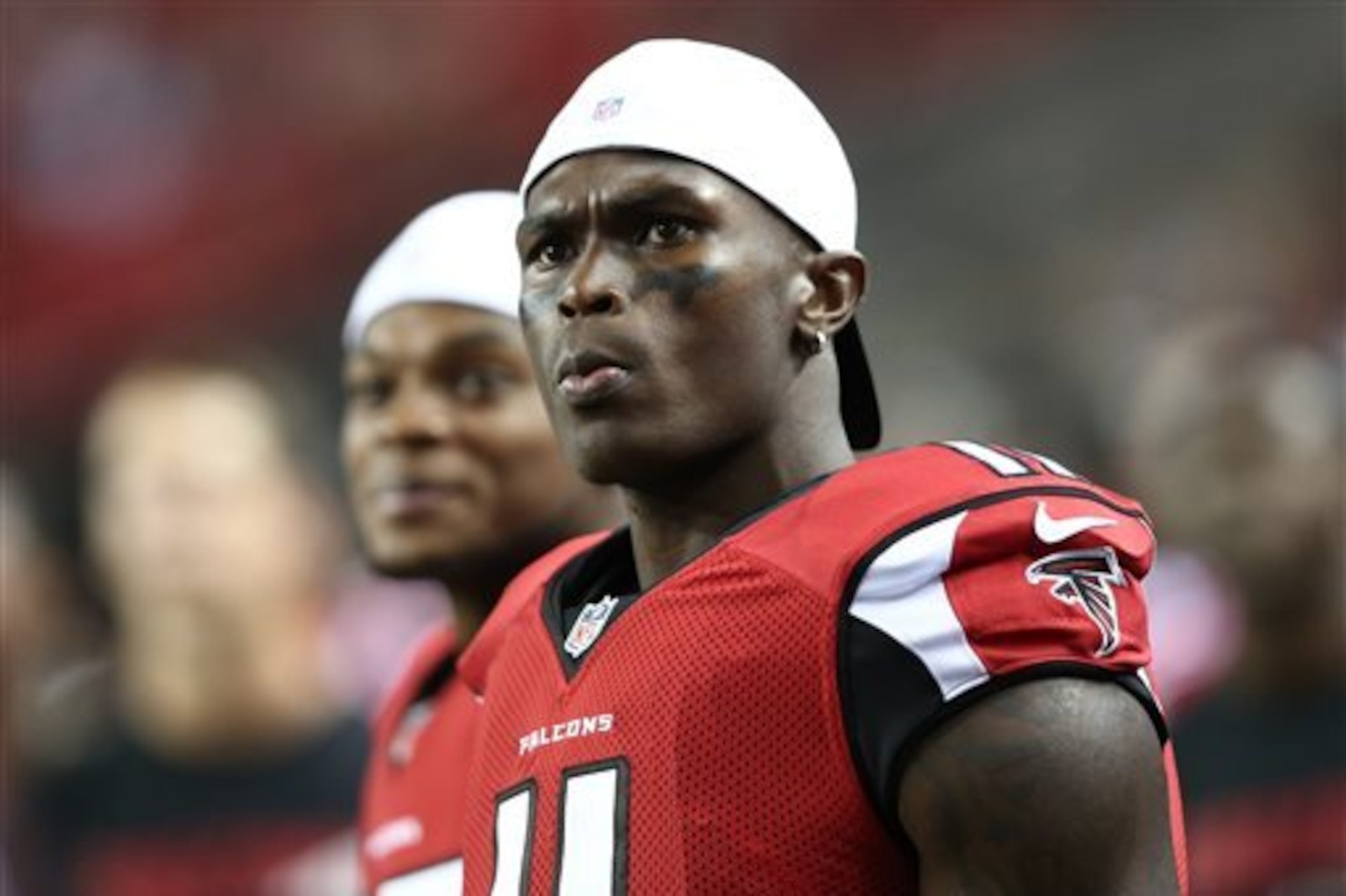 FILE - In this Aug. 14, 2015, file photo, Atlanta Falcons wide receiver Julio Jones (11) watches from the sidelines during the second half of an NFL football preseason game against the Tennessee Titans in Atlanta. As his agent negotiates a new contract with the Falcons, two-time Pro Bowl receiver Julio Jones goes about his business as if nothing has changed. (AP Photo/John Bazemore, File)