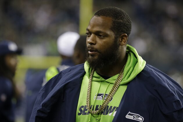 Seattle Seahawks defensive end Michael Bennett stands on the sideline in the second half of a preseason NFL football game against the Oakland Raiders, Thursday, Sept. 3, 2015, in Seattle. (AP Photo/Elaine Thompson)