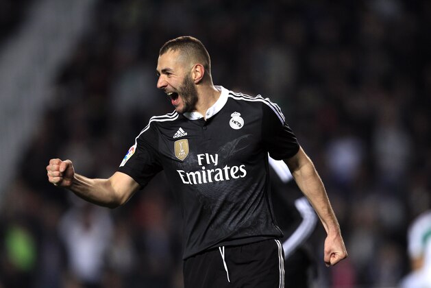 Real Madrid's Karim Benzema, from France celebrates after scoring against Elche during a Spanish La Liga soccer match at the Manuel Martinez Valero stadium in Elche, Spain, on Sunday, Feb. 22, 2015.(AP Photo/Alberto Saiz)
