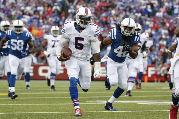 Buffalo Bills quarterback Tyrod Taylor (5) runs past Indianapolis Colts safety Clayton Geathers (42) during the first half of an NFL football game on Sunday, Sept. 13, 2015, in Orchard Park, N.Y. (AP Photo/Bill Wippert)