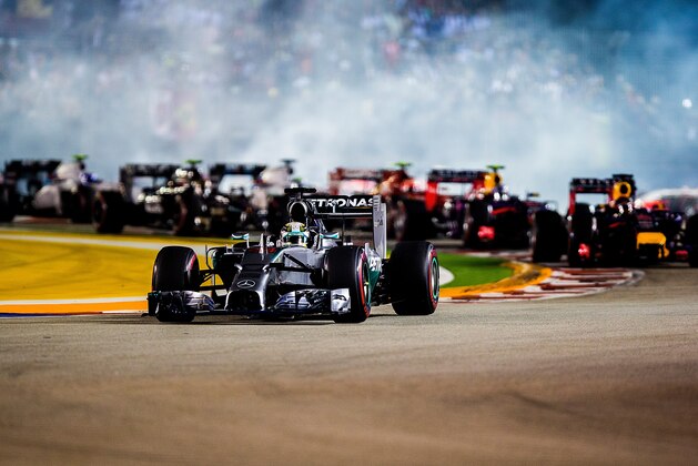 SINGAPORE - SEPTEMBER 21:  Lewis Hamilton of Great Britain and Mercedes GP Petronas leads after the start of the Singapore Formula One Grand Prix at Marina Bay Street Circuit on September 21, 2014 in Singapore, Singapore.  (Photo by Vladimir Rys Photography/Getty Images)