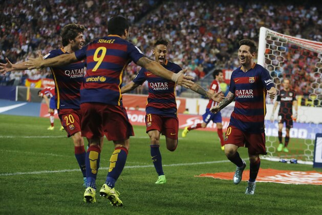 Barcelona’s Lionel Messi, right, celebrates with team mates after scoring during a Spanish La Liga soccer match between Atletico Madrid and Barcelona at the Vicente Calderon stadium in Madrid, Spain, Saturday Sept. 12, 2015. (AP Photo/Paul White)