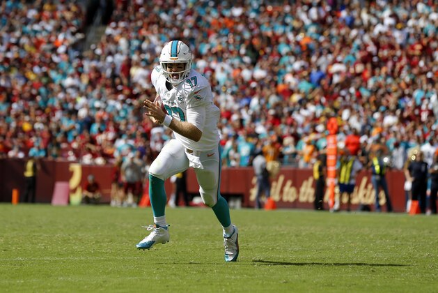Miami Dolphins quarterback Ryan Tannehill rushes the ball during the second half of an NFL football game against the Washington Redskins, Sunday, Sept. 13, 2015, in Landover, Md. (AP Photo/Patrick Semansky)
