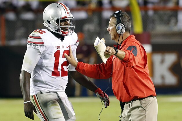 FILE - In this Sept. 7, 2015, file photo, Ohio State head coach Urban Meyer, right, talks with quarterback Cardale Jones (12) during the second half of an NCAA college football game agains Virginia Tech in Blacksburg, Va. Jones is still the starter after a game where Urban Meyer was not particularly happy with either of Ohio State's quarterbacks. He was even less happy with his offensive line.    (AP Photo/Steve Helber, File)