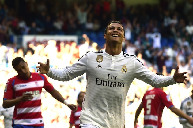 Real Madrid's Portuguese forward Cristiano Ronaldo celebrates a goal during the Spanish league football match Real Madrid CF vs Granada FC at the Santiago Bernabeu stadium in Madrid on April 5, 2015.   AFP PHOTO/ GERARD JULIEN        (Photo credit should read GERARD JULIEN/AFP/Getty Images)