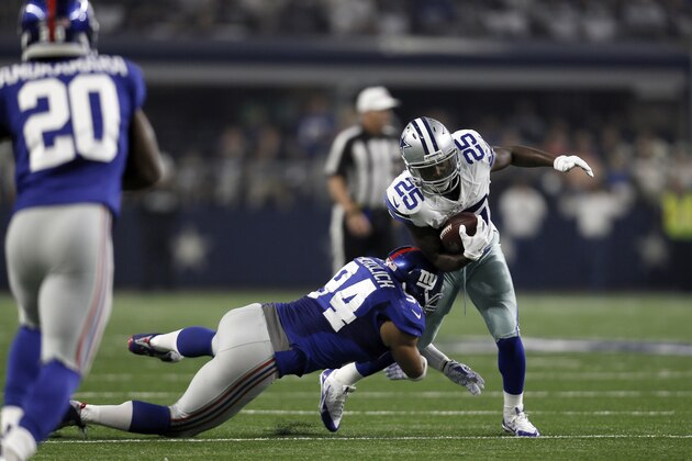 Dallas Cowboys running back Lance Dunbar (25) is tackled by New York Giants outside linebacker Mark Herzlich (94) during the second half of an NFL football game Sunday, Sept. 13, 2015, in Arlington, Texas. (AP Photo/Brandon Wade)