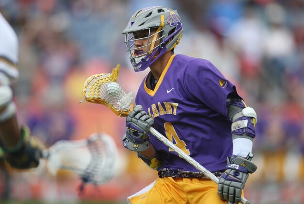 May 16, 2015; Denver, CO, USA; Albany Great Danes attack Lyle Thompson (4) brings the ball up the field during the first quarter against the Notre Dame Fighting Irish at Sports Authority Field at Mile High. Mandatory Credit: Chris Humphreys-USA TODAY Sports