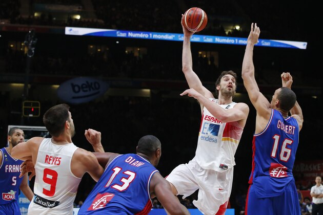 Spain's Pau Gasol, 2nd right, shoots over France's Rudy Gobert, right, to dunk a basket during the EuroBasket European Basketball Championship semifinal match, between France against Spain, at Pierre Mauroy stadium in Lille, northern France, Thursday, Sept. 17, 2015. Spain won 80-75. (AP Photo/Michel Euler)