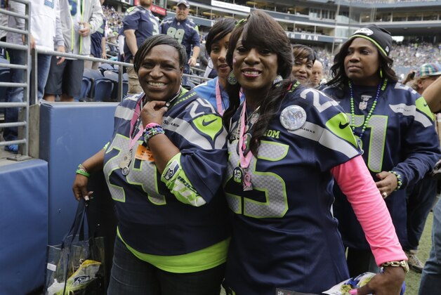Delisa Lynch (left), mother of Seattle Seahawks running back Marshawn Lynch, and Beverly Sherman, mother of Seattle Seahawks cornerback Richard Sherman, stand on the field prior to the start NFL football game between the Seattle Seahawks and the Dallas Cowboys, Sunday, Oct. 12, 2014, in Seattle. (AP Photo/Scott Eklund)