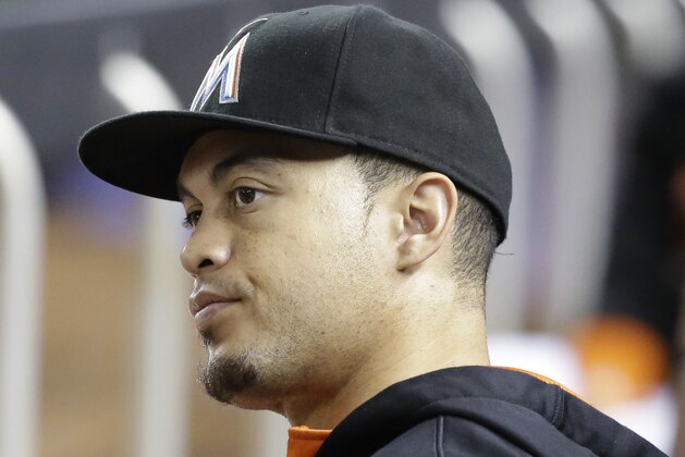 Miami Marlins' Giancarlo Stanton looks out from the dugout during the eighth inning of a baseball game against the Pittsburgh Pirates, Thursday, Aug. 27, 2015, in Miami. The Pirates defeated the Marlins 2-1. (AP Photo/Wilfredo Lee)
