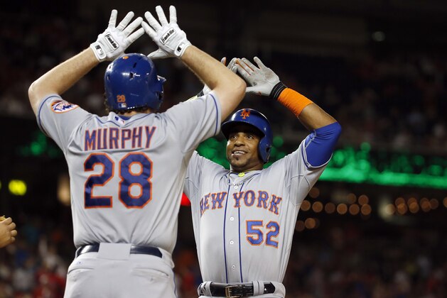 New York Mets' Daniel Murphy celebrates with Yoenis Cespedes (52) after Cespedes' two-run home run during the eighth inning of a baseball game against the Washington Nationals at Nationals Park, Wednesday, Sept. 9, 2015, in Washington. The Mets won 5-3. (AP Photo/Alex Brandon)
