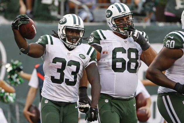 New York Jets running back Chris Ivory (33) celebrates a touchdown with teammate Breno Giacomini (68) during the second half of an NFL football game against the Cleveland Browns Sunday, Sept. 13, 2015 in East Rutherford, N.J. The Jets won 31-10. (AP Photo/Jason DeCrow)