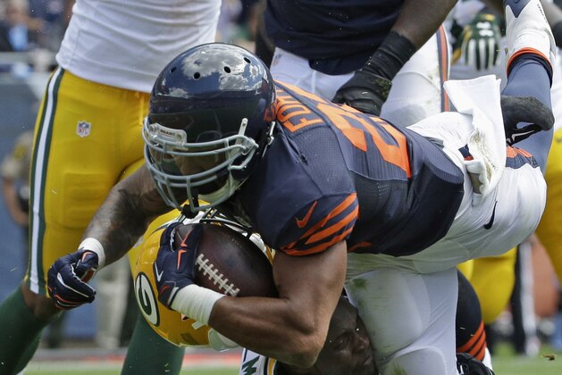 Chicago Bears running back Matt Forte (22) dives into the end zone for a touchdown as Green Bay Packers linebacker Nate Palmer (51) has his helmet knocked off during the first half an NFL football game,  Sunday, Sept. 13, 2015, in Chicago. (AP Photo/Nam Y. Huh)