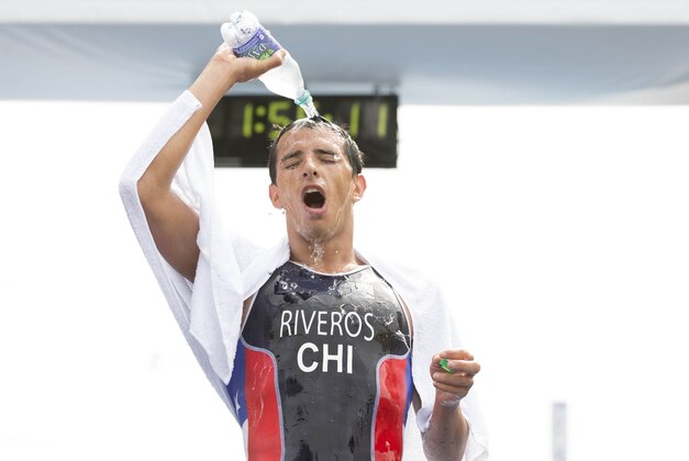 Jul 12, 2015; Toronto, Ontario, CAN; Gaspar Riveros of Chile pours water on his head after completing the men's triathlon during the 2015 Pan Am Games at Ontario Place West Channel. Mandatory Credit: Rob Schumacher-USA TODAY Sports