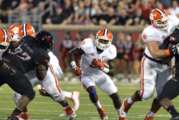 Clemson's Wayne Gallman (9) breaks through a hole in the Louisville defense during the first half of an NCAA college football game in Louisville, Ky., Thursday, Sept. 17, 2015. (AP Photo/Timothy D. Easley) Clemson's Wayne Gallman (9) breaks through a hole in the Louisville defense during the first half of an NCAA college football game in Louisville, Ky., Thursday, Sept. 17, 2015. (AP Photo/Timothy D. Easley)