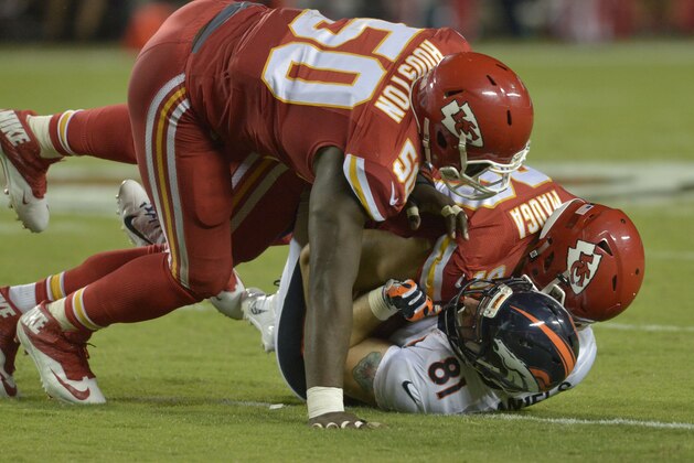 Sep 17, 2015; Kansas City, MO, USA; Denver Broncos tight end Owen Daniels (81) is tackled by Kansas City Chiefs outside linebacker Justin Houston (50) and inside linebacker Josh Mauga (90) during the second half at Arrowhead Stadium. The Broncos won 31-24. Mandatory Credit: Denny Medley-USA TODAY Sports