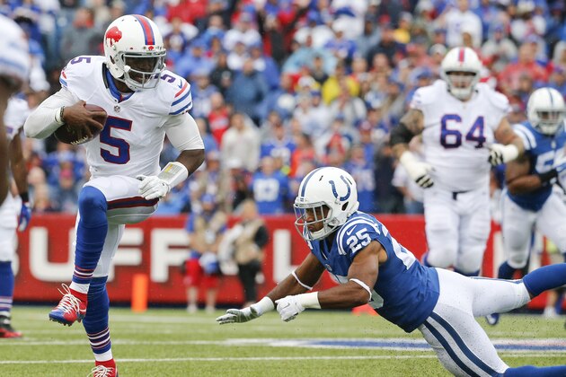 Buffalo Bills quarterback Tyrod Taylor (5) eludes Indianapolis Colts defensive back Jalil Brown (25) during the first half of an NFL football game on Sunday, Sept. 13, 2015, in Orchard Park, N.Y. (AP Photo/Bill Wippert)