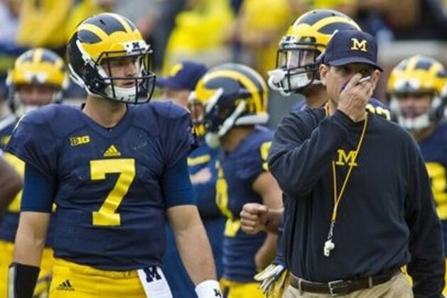 Michigan quarterback Shane Morris (7) waits for instructions from head coach Jim Harbaugh, center, during warmups before an NCAA college football game against Oregon State in Ann Arbor, Mich., Saturday, Sept. 12, 2015. (AP Photo/Tony Ding)