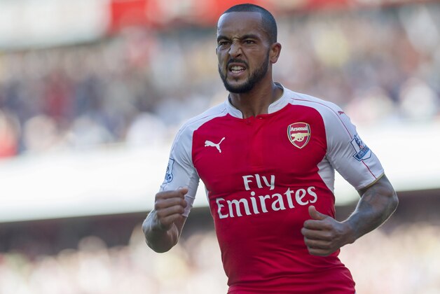 Arsenal's Theo Walcott celebrates after scoring against Stoke City, during their English Premier League soccer match between Arsenal and Stoke City, at Emirates Stadium, in London, Saturday, Sept. 12, 2015. (AP Photo/Bogdan Maran)