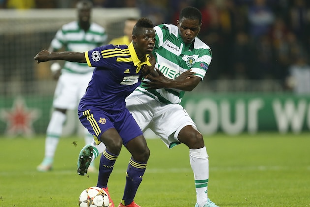 Maribor's Sintayehu Sallalich, left, fights for the ball with Sporting's William Carvalho during the Champions League Group G soccer match between Maribor and Sporting, in Maribor, Slovenia, Wednesday, Sept. 17, 2014. (AP Photo/Darko Bandic)