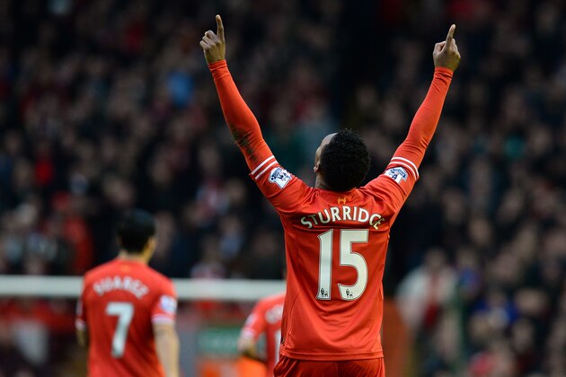 Liverpool's English striker Daniel Sturridge (R) celebrates scoring the opening goal during the English Premier League football match between Liverpool and Swansea City at Anfield in Liverpool, northwest England on February 23, 2014. AFP PHOTO / ANDREW YATES

RESTRICTED TO EDITORIAL USE. No use with unauthorized audio, video, data, fixture lists, club/league logos or live services. Online in-match use limited to 45 images, no video emulation. No use in betting, games or single club/league/player publications.        (Photo credit should read ANDREW YATES/AFP/Getty Images)