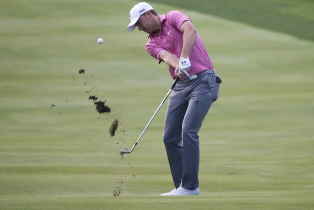 Jordan Spieth hits his approach shot to the ninth green to finish the rain postponed first round of the BMW Championship golf tournament at Conway Farms Golf Club, Friday, Sept. 18, 2015, in Lake Forest, Ill. (AP Photo/Charles Rex Arbogast)
