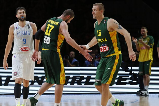 Lithuania's Jonas Valanciunas, center, is congratulate by his teammate Robertas Javtokas, after he dunks a basket during the EuroBasket European Basketball Championship quarterfinal match, between Italy and Lithuania, at Pierre Mauroy stadium in Lille, northern France, Wednesday, Sept. 16, 2015. Lithuania won 95-85. (AP Photo/Michel Euler)