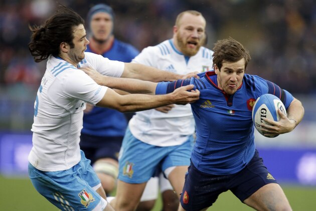 France’s Camille Lopez, right, is tackled by Italy’s Luke McLean during a Six Nations rugby union match between Italy and France, at Rome's Olympic Stadium, Sunday, March 15, 2015. (AP Photo/Andrew Medichini)