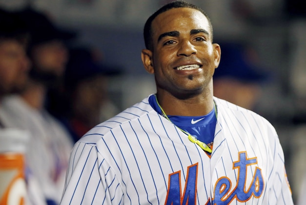 New York Mets Yoenis Cespedes smiles in the dugout after hitTing a third-inning, solo, home run in a baseball game against the Miami Marlins in New York, Monday, Sept. 14, 2015. (AP Photo/Kathy Willens)