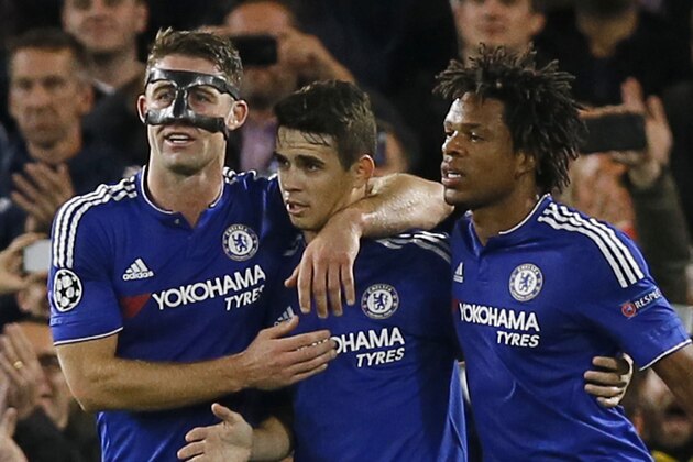 Chelsea's Gary Cahill, left, and Loic Remy, right, hug Oscar, center, after he scored 2-0 with a penalty during the Champions League group G soccer match between Chelsea and Maccabi Tel Aviv at Stamford Bridge stadium in London, Wednesday, Sept. 16, 2015.(AP Photo/Kirsty Wigglesworth)