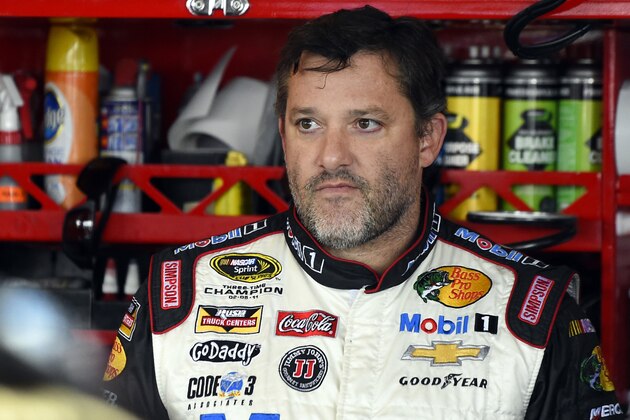 FILE - In this Sept. 13, 2014, file photo, Tony Stewart looks out from his garage during practice for the NASCAR Sprint Cup series auto race at Chicagoland Speedway in Joliet, Ill. A grand jury decided against charging Stewart in the death of Kevin Ward Jr. on a dirt track last month in upstate New York. Stewart took three weeks off from racing after the crash. (AP Photo/Paul J. Bergstrom, File)