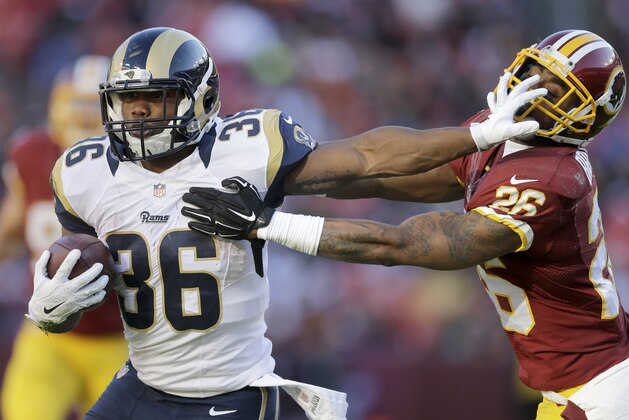 St. Louis Rams running back Benny Cunningham (36) pushes Washington Redskins cornerback Bashaud Breeland (26) back during the first half of an NFL football game in Landover, Md., Sunday, Dec. 7, 2014. (AP Photo/Patrick Semansky)