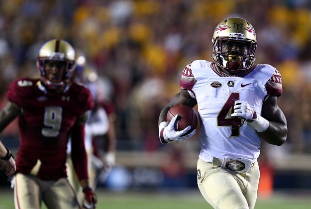 Sep 18, 2015; Boston, MA, USA; Florida State Seminoles running back Dalvin Cook (4) runs the ball against Boston College Eagles defensive back John Johnson (9) during the first half at Alumni Stadium. Mandatory Credit: Mark L. Baer-USA TODAY Sports