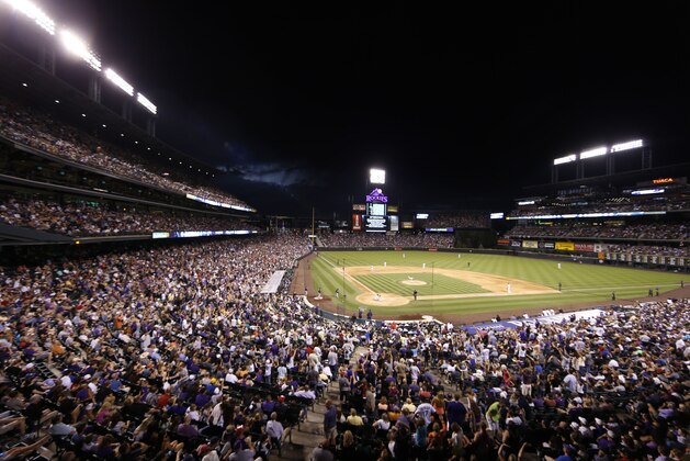 Fans fill the stands of Coors Field as the Colorado Rockies host the Atlanta Braves in the eighth inning of a baseball game Friday, July 10, 2015, in Denver. Colorado won 5-3. (AP Photo/David Zalubowski)