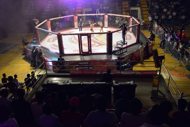 TO GO WITH AFP STORY: Cambodia-lifestyle-sport-MMA,FEATURE by Suy SE
This photo taken on August 24, 2014 shows a general view of a Cambodian cage fight for a local television (TV) programme at a statium in Phnom Penh. He is schooled in ancient Cambodian martial arts, but Tok Sophon hopes to turn his pugilism skills into wealth and international glory in the modern cage-fighting arena -- a transition some fighters fear will wipe out their craft.     AFP PHOTO/TANG CHHIN SOTHY        (Photo credit should read TANG CHHIN SOTHY/AFP/Getty Images)