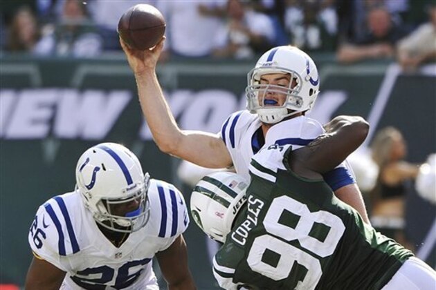 FILE - In this Sunday, Oct. 14, 2012, file photo, Indianapolis Colts quarterback Andrew Luck is sacked by New York Jets defensive end Quinton Coples (98) while attempting to pass the ball as teammate Mewelde Moore (26) watches during an NFL football game in East Rutherford, N.J. Rex Ryan's defense had its best performance a week ago, shutting down rookie Luck and the Indianapolis offense. On Sunday, Oct. 21, the Colts face the New England Patriots and their up-temp offense. (AP Photo/Bill Kostroun, File)