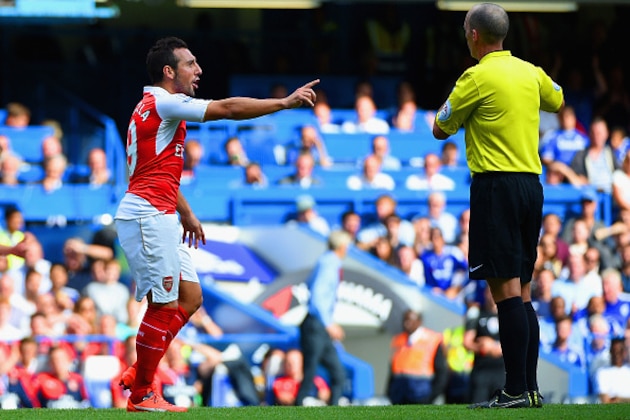 LONDON, ENGLAND - SEPTEMBER 19: Referee Mike Dean prepares to show the second yellow card to  Santi Cazorla of Arsenal during the Barclays Premier League match between Chelsea and Arsenal at Stamford Bridge on September 19, 2015 in London, United Kingdom.  (Photo by Ross Kinnaird/Getty Images)
