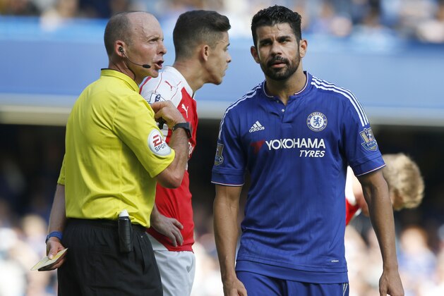 Referee Michael Dean holds a yellow cards after booking both Chelsea's Diego Costa, right, and Arsenal's Gabriel during the English Premier League soccer match between Chelsea and Arsenal at Stamford Bridge stadium in London, Saturday, Sept. 19 2015. Arsenal's Gabriel was sent off moments later for a further clash with Costa .(AP Photo/Alastair Grant) Referee Michael Dean holds a yellow cards after booking both Chelsea's Diego Costa, right, and Arsenal's Gabriel during the English Premier League soccer match between Chelsea and Arsenal at Stamford Bridge stadium in London, Saturday, Sept. 19 2015. Arsenal's Gabriel was sent off moments later for a further clash with Costa .(AP Photo/Alastair Grant)
