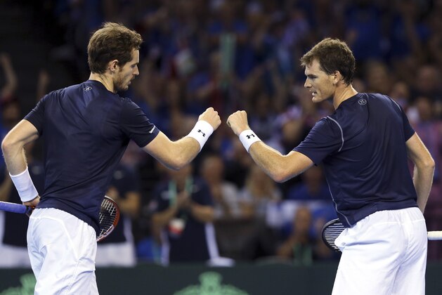 Britain's Andy Murray, left, and Jamie Murray, right, celebrate winning a point from Australia's Sam Groth and Lleyton Hewitt during the semifinal doubles tennis match between Britain and Australia of the Davis Cup in Glasgow, Saturday Sept. 19, 2015. (AP Photo/Scott Heppell)