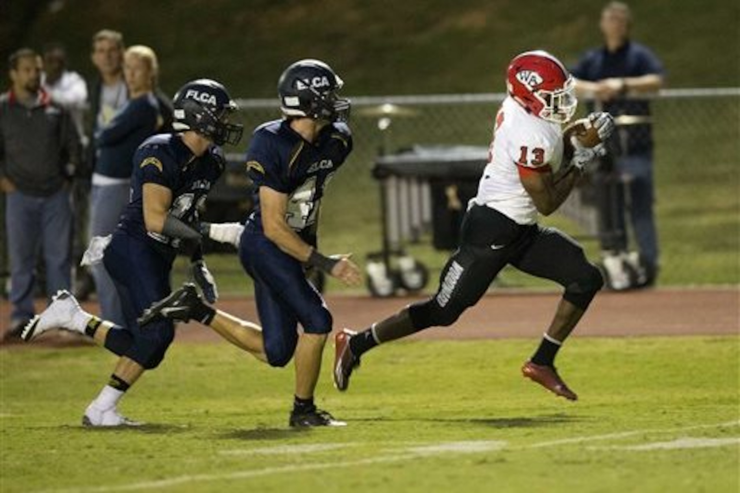 FILE - In this Sept. 26, 2014, file photo, Woodward Academy running back Elijah Holyfield runs for a touchdown after catching a pass against Eagle's Landing Christian Academy in the first half of a high school football game in Stockbridge, Ga. Holyfield, the top-rated running back in the state of Georgia and the son of former boxing champion Evander Holyfield, says he will sign with Georgia. Holyfield announced his decision on Friday, Sept. 4, 2015.(AP Photo/John Bazemore, File) FILE - In this Sept. 26, 2014, file photo, Woodward Academy running back Elijah Holyfield runs for a touchdown after catching a pass against Eagle's Landing Christian Academy in the first half of a high school football game in Stockbridge, Ga. Holyfield, the top-rated running back in the state of Georgia and the son of former boxing champion Evander Holyfield, says he will sign with Georgia. Holyfield announced his decision on Friday, Sept. 4, 2015.(AP Photo/John Bazemore, File)