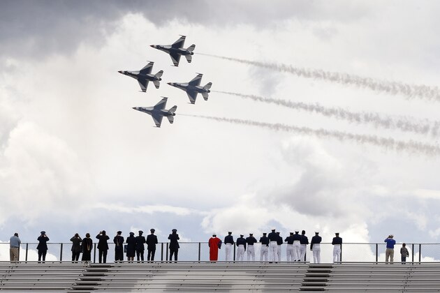 F-16 jets from the Thunderbirds make a flyover following the completion of the Air Force Academy graduation ceremony for the class of  2015, at the U.S. Air Force Academy, in Colorado Springs, Colo., Thursday, May 28, 2015.  (AP Photo/Brennan Linsley)