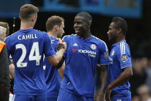 Chelsea's Kurt Zouma, centre is congratulated  by teammate Chelsea's Gary Cahill after the end of the English Premier League soccer match between Chelsea and Arsenal at Stamford Bridge stadium in London, Saturday, Sept. 19, 2015. Zouma scored the first goal in Chelsea's 2-0 win over Arsenal.(AP Photo/Alastair Grant)